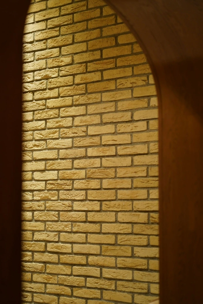 Brick wall framed by an archway.